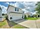 Two-story home with attached garage and landscaped yard at 372 Willet St, Haines City, FL 33844