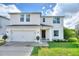 Two-story home with attached garage and landscaped yard at 372 Willet St, Haines City, FL 33844