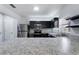 Modern kitchen with dark cabinets, stainless steel appliances, and granite countertops at 372 Willet St, Haines City, FL 33844