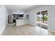 Modern kitchen featuring stainless steel appliances, granite counters, and a sliding glass door to the outdoor patio at 372 Willet St, Haines City, FL 33844