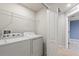 A laundry room with a full-size washer and dryer with wire shelving for easy storage at 372 Willet St, Haines City, FL 33844