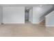 Open living area with staircase and views of the kitchen and front entry at 372 Willet St, Haines City, FL 33844