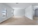 Spacious living room with neutral carpet, bright windows, and open layout at 372 Willet St, Haines City, FL 33844