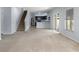Open-concept living area with stairs, kitchen, and a view of the backyard at 372 Willet St, Haines City, FL 33844