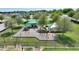 A playground featuring modern play equipment, climbing structures, and shaded picnic areas perfect for Gathering fun in a residential community at 372 Willet St, Haines City, FL 33844