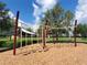 Community playground featuring climbing equipment, covered seating, and wood chip safety surface at 372 Willet St, Haines City, FL 33844