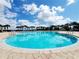 Community pool on a sunny day with clear water and a beautiful sky at 372 Willet St, Haines City, FL 33844