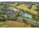 Beautiful aerial view of community amenities including the pool, clubhouse, tennis and basketball courts at 3843 Beacon Ridge Way, Clermont, FL 34711