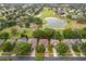 Aerial view highlighting a home in a community near a golf course and pond, blending recreation and residence at 3843 Beacon Ridge Way, Clermont, FL 34711