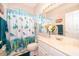 Bathroom featuring a vanity with a sink, a toilet, and a shower with a cute curtain at 3843 Beacon Ridge Way, Clermont, FL 34711
