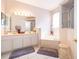 Bright bathroom featuring double sinks, a soaking tub, and a separate glass-enclosed shower at 3843 Beacon Ridge Way, Clermont, FL 34711