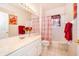 Bathroom featuring a vanity with a sink, a toilet, and a shower with a red and white curtain at 3843 Beacon Ridge Way, Clermont, FL 34711