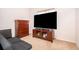Bedroom featuring a large TV, dresser, and a futon at 3843 Beacon Ridge Way, Clermont, FL 34711