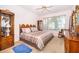 Comfortable bedroom with a queen-size bed, neutral carpeting, and a bright window at 3843 Beacon Ridge Way, Clermont, FL 34711