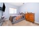 Bedroom featuring a small window, queen-sized bed, and blue painted walls at 3843 Beacon Ridge Way, Clermont, FL 34711