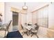 Cozy dining area with tile flooring, bright window, and sliding glass door to the outside at 3843 Beacon Ridge Way, Clermont, FL 34711