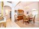 Cozy dining area with a wooden table, chandelier, and view into other rooms at 3843 Beacon Ridge Way, Clermont, FL 34711
