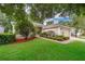 Well-maintained home with mature landscaping, colorful mulch, and lush green grass at 3843 Beacon Ridge Way, Clermont, FL 34711
