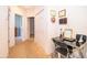 Hallway with neutral carpet leads to bedrooms, complemented by a functional workspace featuring a modern glass desk at 3843 Beacon Ridge Way, Clermont, FL 34711