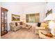 Cozy living room featuring neutral carpet, ample light, and comfortable seating at 3843 Beacon Ridge Way, Clermont, FL 34711