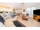 Open-concept living room featuring a seamless flow to the kitchen and a comfortable seating arrangement at 3843 Beacon Ridge Way, Clermont, FL 34711