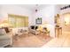 Comfortable living room featuring neutral carpet, large windows, and ornate decor at 3843 Beacon Ridge Way, Clermont, FL 34711
