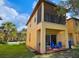 Back porch area with seating, a sliding glass door, and a view of the lawn at 4031 Calabria Avenue, Davenport, FL 33897