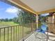 Enjoy a tranquil view from this spacious balcony with outdoor seating, overlooking greenery at 4031 Calabria Avenue, Davenport, FL 33897
