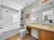 Clean and well-maintained bathroom with a combined tub and shower, ample lighting, and modern fixtures at 4031 Calabria Avenue, Davenport, FL 33897