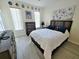 Bright bedroom with modern flooring, a comfortable bed, dresser and minimalist decor at 4031 Calabria Avenue, Davenport, FL 33897