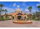Upscale clubhouse with palm trees, fountain, and inviting entrance at 4031 Calabria Avenue, Davenport, FL 33897