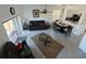 Bright living area with modern flooring, comfortable seating, a ceiling fan, and an adjacent dining space at 4031 Calabria Avenue, Davenport, FL 33897