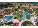 Aerial view of the community pool area, with lounge chairs and palm trees surrounding blue, inviting waters at 4031 Calabria Avenue, Davenport, FL 33897