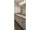 Bathroom vanity featuring double sinks, granite countertop and bright lighting at 4062 Serene Water Ave, Eustis, FL 32736