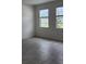 Bright room with neutral walls, tile floor, and two windows at 4062 Serene Water Ave, Eustis, FL 32736