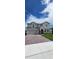 Charming two-story home features a brick driveway, a gray exterior, a two-car garage, and manicured landscaping at 4062 Serene Water Ave, Eustis, FL 32736