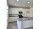 Modern kitchen featuring white cabinets, stainless steel appliances, and granite countertops at 4062 Serene Water Ave, Eustis, FL 32736