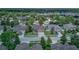 Aerial view of home with a private pool in a neighborhood with mature trees at 420 Tulipwood Ln, Chuluota, FL 32766