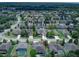 Aerial view showcases lush green community, mature trees, and a backyard pool at 420 Tulipwood Ln, Chuluota, FL 32766