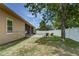 Large backyard features an open patio, lawn chairs, and privacy fence at 420 Tulipwood Ln, Chuluota, FL 32766