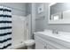 Bright bathroom featuring a shower, white tiled walls and a blue and white striped shower curtain at 420 Tulipwood Ln, Chuluota, FL 32766