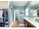 Spacious bathroom with dual sinks, walk-in closet, separate toilet room, and neutral-toned tile flooring at 420 Tulipwood Ln, Chuluota, FL 32766