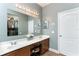Bathroom featuring double sinks, large mirror, vanity, and walk-in closet providing ample storage and functionality at 420 Tulipwood Ln, Chuluota, FL 32766