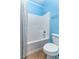 Bathroom featuring a white tiled shower and tub combination and toilet at 420 Tulipwood Ln, Chuluota, FL 32766