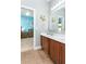 Bathroom featuring double sinks, a large mirror, vanity, and a doorway into an adjacent room at 420 Tulipwood Ln, Chuluota, FL 32766