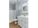 Well-lit bathroom featuring a shower, toilet, single sink vanity, and a modern design for a clean aesthetic at 420 Tulipwood Ln, Chuluota, FL 32766
