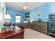 Cozy bedroom with desk, dresser, mounted memorabilia, and a comfortable bed under a ceiling fan at 420 Tulipwood Ln, Chuluota, FL 32766
