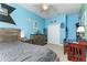 Well-lit bedroom featuring a bed, dresser, ceiling fan, and decor creating a fun and personal space at 420 Tulipwood Ln, Chuluota, FL 32766