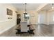 Bright dining area with a large wooden table, comfortable seating, and a view to the entrance at 420 Tulipwood Ln, Chuluota, FL 32766