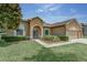 Charming home with well-manicured lawn, tidy landscaping, and neutral colored exterior at 420 Tulipwood Ln, Chuluota, FL 32766
